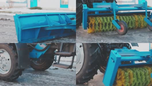 带铲子和旋转刷的轮式拖拉机清除街道上的积雪和灰尘。慢动作视频高清在线视频素材下载