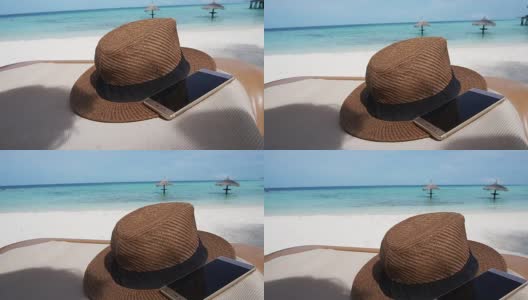 草帽智能手机在马尔代夫海洋海洋。假日放松抽象背景高清在线视频素材下载