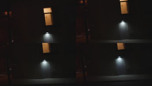 夜间，镜头移向巷子附近的可疑城市门口，灯光昏暗高清在线视频素材下载