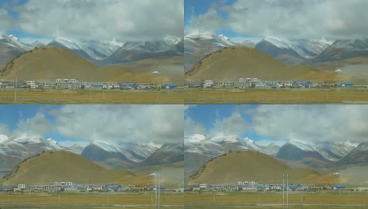 在西藏平原的村庄后面，有雪景如画的喜马拉雅高清在线视频素材下载