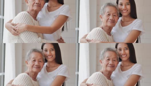肖像快乐的志愿者年轻的黑人妇女护士看门人与亚洲老祖母说话，耐心的笑，在家里看着照相机。医疗、卫生保健、照顾、关心,退休,家庭,生活方式,志愿者,慈善,养老院的概念。高清在线视频素材下载