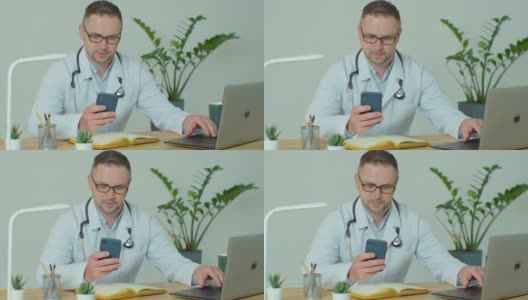 穿着白大褂的男医生使用带有触摸屏的现代智能手机。医生使用手机向患者发送短信，告知医疗检查结果。高清在线视频素材下载
