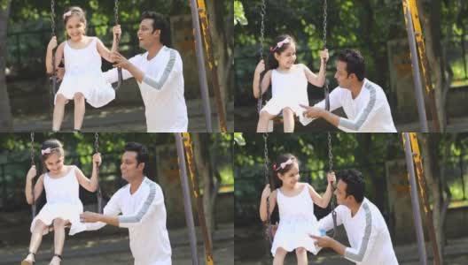 父亲和女儿在公园荡秋千高清在线视频素材下载