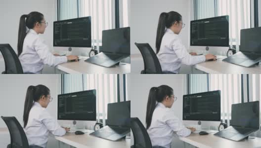 亚洲女性软件开发人员正在分析写进办公室电脑程序的代码。高清在线视频素材下载