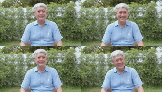 肖像亚洲华人老人在家里开心的微笑。老男性放松牙齿微笑看相机，而躺在花园里的概念在家里的早晨。高清在线视频素材下载