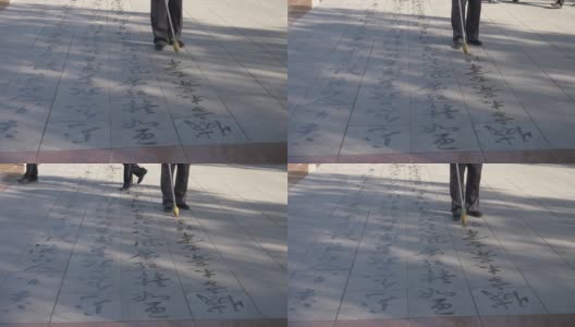 在中国甘肃张掖，人们用毛笔在地上书写佛经。高清在线视频素材下载