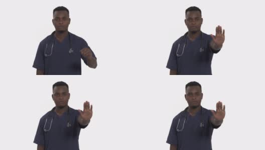 严肃医生的肖像在专业医疗蓝色外套显示拒绝手势由停止手掌符号。医生被隔离在白色背景下高清在线视频素材下载