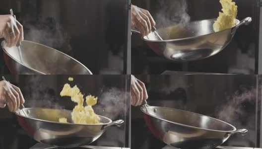 厨师在钢锅里煎蛋卷，特写慢动作。高清在线视频素材下载