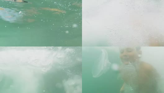 这个男孩在水母中间游到海里高清在线视频素材下载