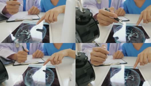两位医生在平板电脑上分析数字胶片，慢动作高清在线视频素材下载