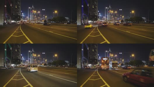 车辆行驶在繁忙的道路上在香港的夜晚与风景优美的高楼大厦的背景-广角镜头高清在线视频素材下载