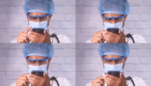 体贴的医生在使用智能手机面罩。高清在线视频素材下载