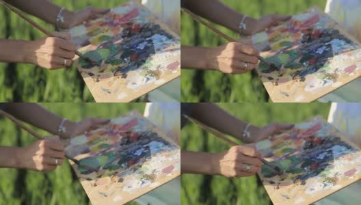 在田野里用油画颜料作画的女艺术家高清在线视频素材下载