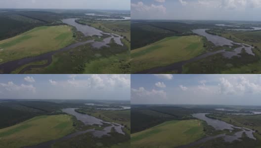 江水在原野中，绿草在河谷中架空。没有人在春天的太阳日自然景观。自然美景。森林中的田园绿意。海岸农田绿化高清在线视频素材下载