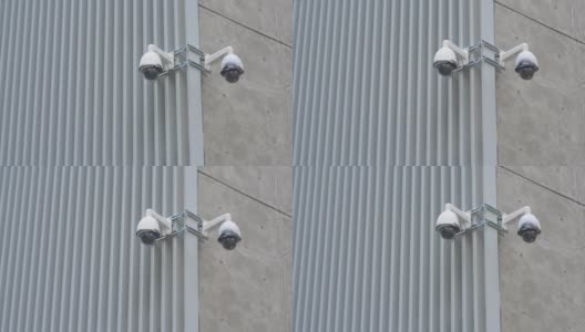 夏日的亚洲城市，建筑物的墙上挂着摄像头高清在线视频素材下载