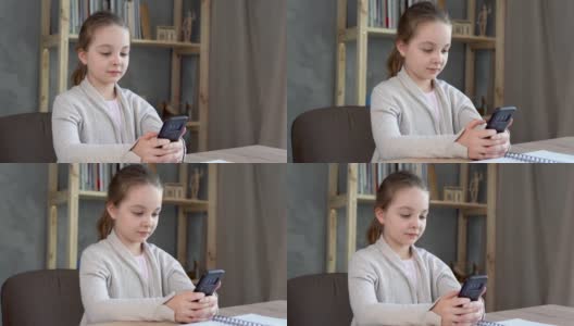 在探索一个坐在走廊桌子边用智能手机玩的白人小女孩时，休息一下，高清在线视频素材下载