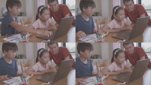 混合种族的亚洲儿童一起学习编码，在家远程学习，STEM科学，电子学习，家庭教育，社会距离，新常态概念高清在线视频素材下载