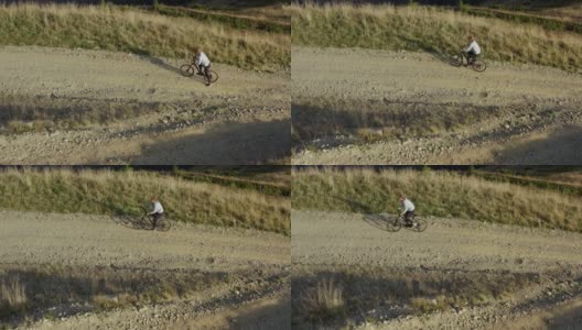 山地自行车骑无人机观看岩石草地路径温暖阳光灿烂的夏日假期高清在线视频素材下载