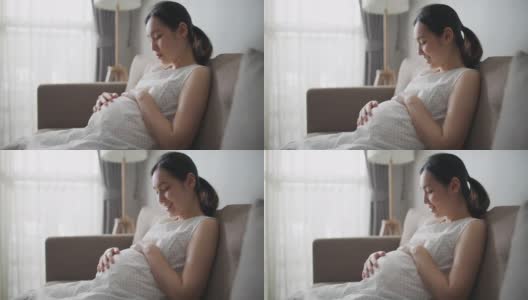 孕妇抚摸她的肚子高清在线视频素材下载