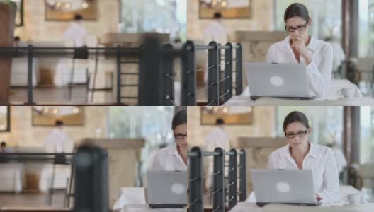 高清多莉:商业女性使用笔记本电脑在Café高清在线视频素材下载