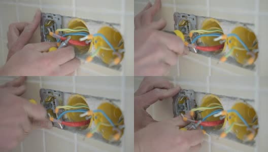 电工双手安装电线插头到墙上高清在线视频素材下载