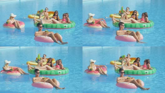 慢镜头:快乐的年轻朋友们在充气浮子上享受暑假高清在线视频素材下载