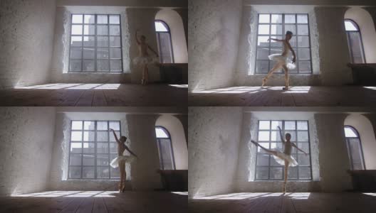 女芭蕾舞演员在阁楼风格的工作室在大窗户前训练高清在线视频素材下载