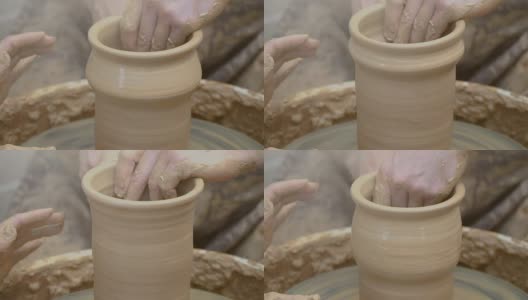 两只手交织在一起，在陶工转盘上形成一个陶罐。高清在线视频素材下载