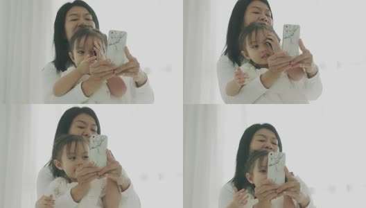 泰国母女用智能手机自拍泰国家庭的现代生活方式高清在线视频素材下载