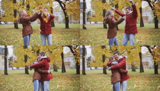 快乐的年轻夫妇在公园里扔秋叶高清在线视频素材下载