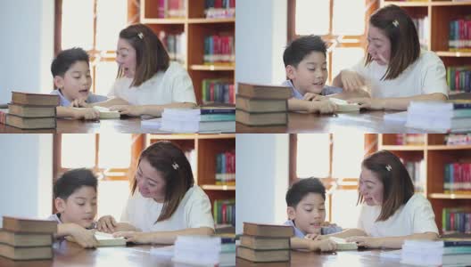 与老师一起阅读——一个小学男孩为她的老师朗读高清在线视频素材下载