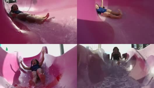 女孩在水上乐园滑滑梯高清在线视频素材下载