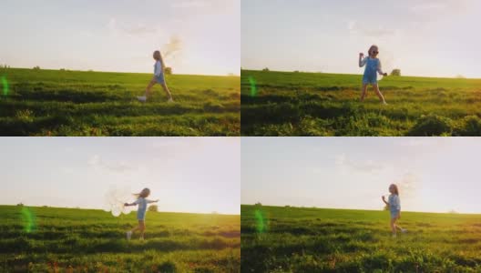 戴着粉色眼镜和气球的小女孩。走在乡间小路上，背景是绿色的草地和蓝色的天空。一个快乐的童年，一个童年的梦想高清在线视频素材下载