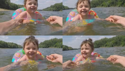 快乐的孩子在水中围成一个充气圈高清在线视频素材下载