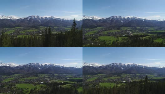 积雪覆盖的高山鸟瞰图。阳光明媚的泰特拉山，绿树和落基山脉的景色。青山山谷和雪山。高清在线视频素材下载