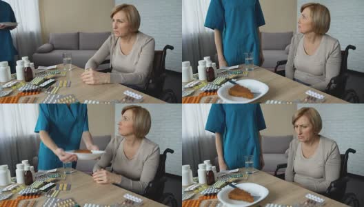 不高兴的老太太把一块馅饼移开放在桌子上，护理人员留在家里高清在线视频素材下载