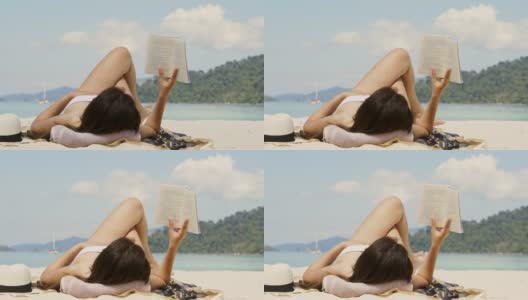 暑假亚洲女人在海滩上读一本书在空闲时间假期高清在线视频素材下载