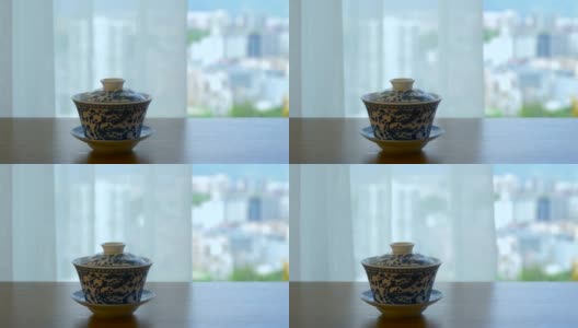 中国茶杯放在窗户旁边的桌子上高清在线视频素材下载