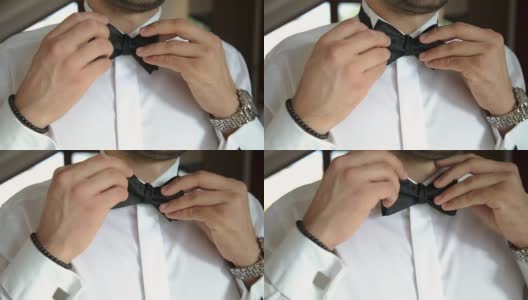 男人正了正白衬衫上的领结高清在线视频素材下载