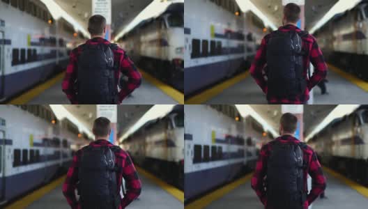 慢镜头:美丽的年轻男子走在洛杉矶火车站的站台上。千禧的概念在暑假，旅游冒险，城市生活方式。高清在线视频素材下载