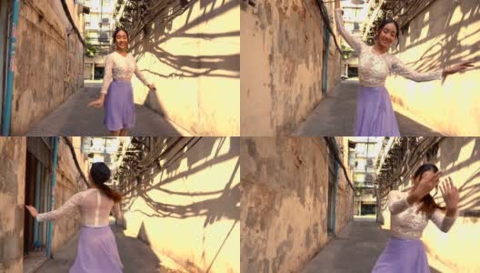 年轻美丽的芭蕾舞演员沿着街道跳舞高清在线视频素材下载