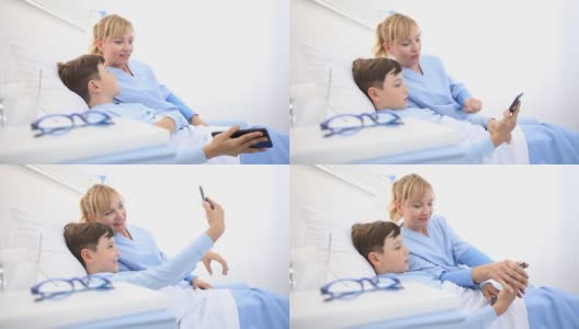 护士在医院里用躺在床上的手机自拍照顾一个孩子高清在线视频素材下载