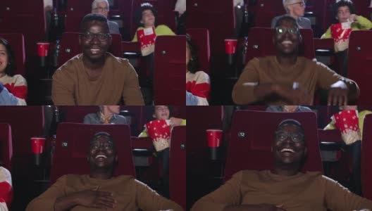 年轻的非裔美国人在电影院欣赏有趣的电影高清在线视频素材下载