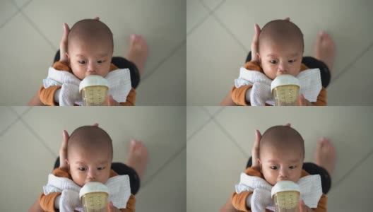 亚洲婴儿喝奶瓶里的牛奶高清在线视频素材下载