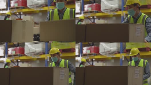一名男性仓库工人在仓库堆放纸箱高清在线视频素材下载