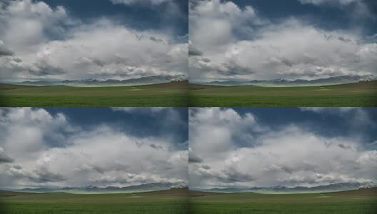 绿色的草地和地平线上的山脉在云。间隔拍摄4 k高清在线视频素材下载