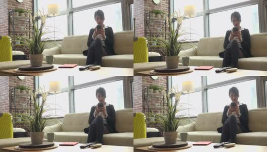 亚洲女性商业女性在家里使用智能手机高清在线视频素材下载