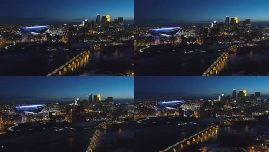 从石拱桥鸟瞰夜间明尼阿波利斯的天际线高清在线视频素材下载