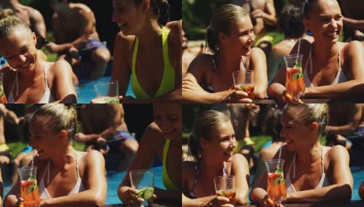 微笑的女人喝着鸡尾酒，在游泳池里玩耍高清在线视频素材下载