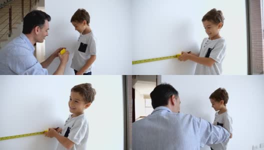 可爱的小男孩在爸爸的帮助下学习如何测量墙壁和使用卷尺高清在线视频素材下载